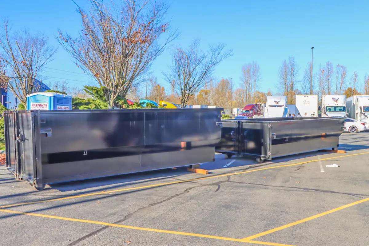 Professional dumpster rental service with roll-off container on residential driveway in Fern Park